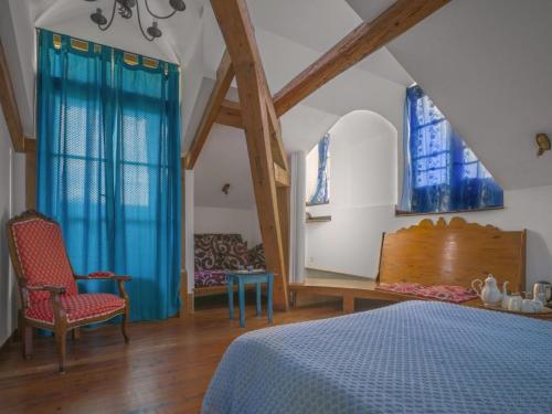 LabordePetit Château的一间卧室设有蓝色的床和2个窗户。