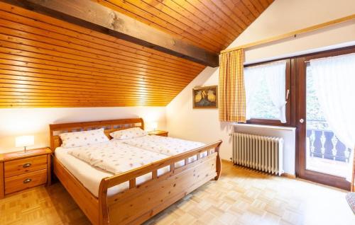 西蒙斯瓦尔德城堡山景观酒店的一间卧室设有一张床和木制天花板