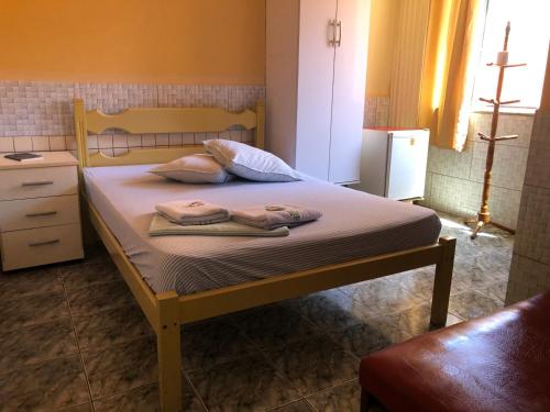 里约达欧特拉斯Pousada Beira Mar的一间卧室配有一张床,上面有两条毛巾