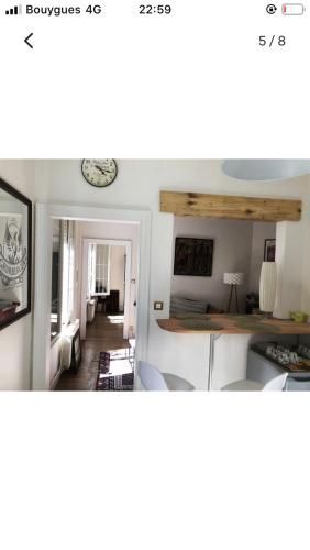 里摩日Maison cocooning avec petit jardin privatif的厨房以及带桌椅的起居室。