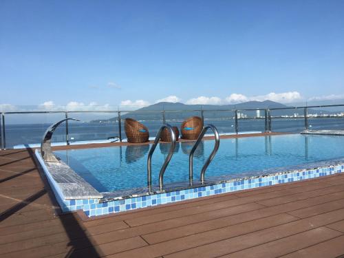 岘港Gold Boutique Hotel Danang的水中有两个金属雕塑的游泳池