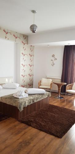 布加勒斯特Mosilor Apartments的一间卧室配有两张床和一张桌子及椅子