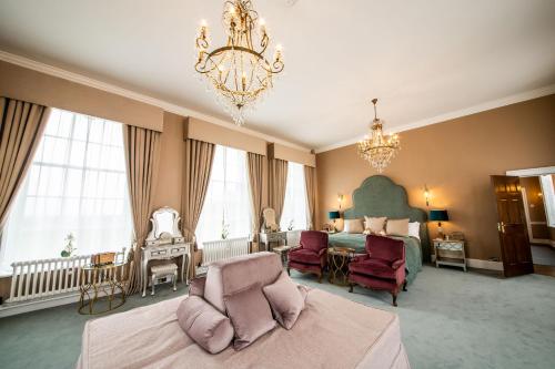 什鲁斯伯里Hawkstone Hall Hotel & Gardens的一间带一张床和吊灯的大卧室