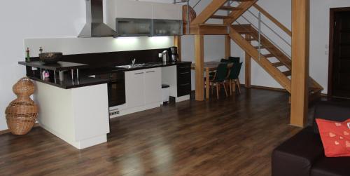 利普托斯基米库拉斯维旺迪度假屋的一间厨房,内设白色橱柜和楼梯
