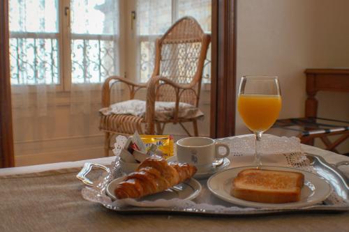 希洪阿斯图里亚斯酒店的托盘早餐食品和一杯橙汁