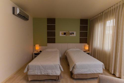 新汉堡市拉肯达酒店的绿墙客房内的两张床