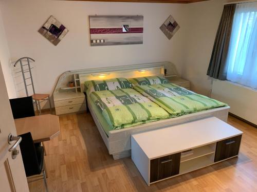 Bannwil埃尔公寓的一间小卧室,配有一张床和一张桌子