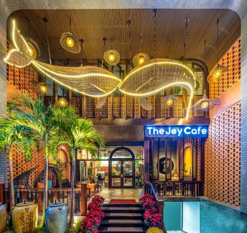 岘港Seahorse Tropical Da Nang Hotel by Haviland的棕榈树和标志的豪华酒店的大堂