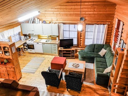 萨利色尔卡Holiday Home Villemi by Interhome的一间带绿色沙发的客厅和一间厨房