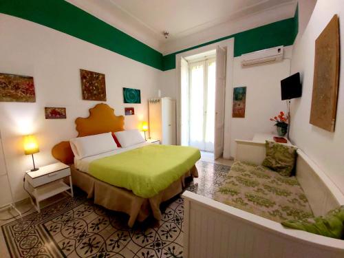 那不勒斯B&B Platamon的一间卧室设有一张床和绿色的墙