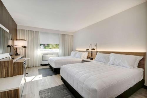 萨克拉门托Wyndham Garden Sacramento Airport Natomas的酒店客房设有两张床和窗户。
