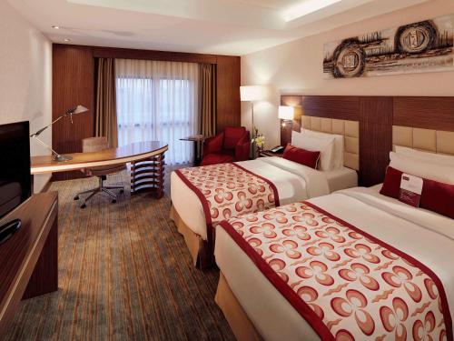 美居伊斯坦布尔阿尔图尼匝德酒店客房内的一张或多张床位