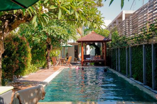 海神庙蒂萨瓦别墅酒店的一个带凉亭和水中鸭子的游泳池