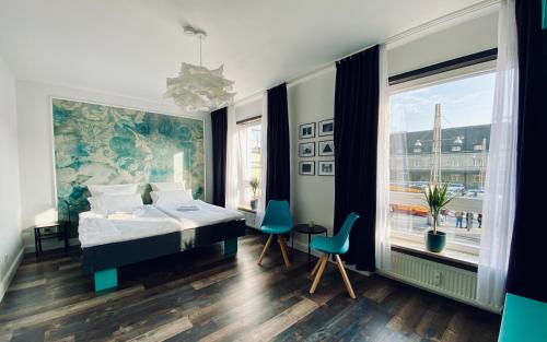 卡尔斯鲁厄zentrales 130 qm Design-Appartement mit Extras的一间卧室设有一张床和一个大窗户