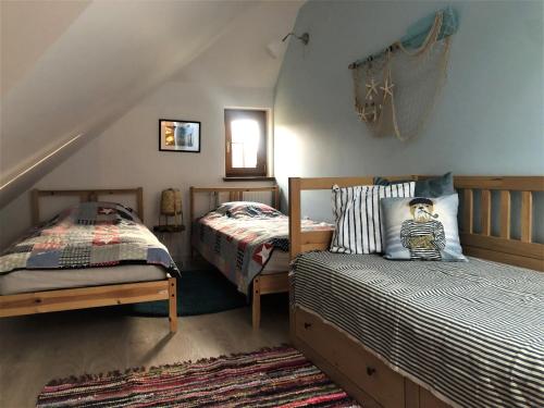 洛格沃Sea You Blue House的一间卧室配有两张床和一张床套