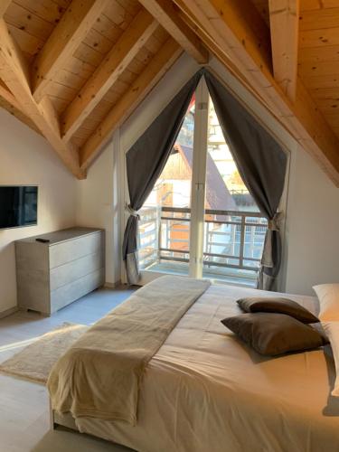 泰穆Alpin Sky的一间卧室设有一张大床和大窗户