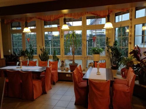 奥拉宁鲍姆Pension Schulze的餐厅设有2张桌子和椅子以及窗户。