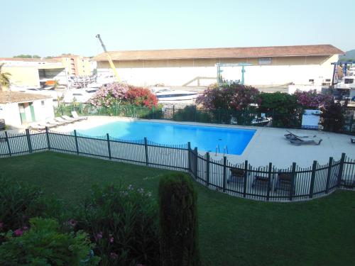 格里莫Luxury apartment in Port Grimaud的院子中游泳池周围的围栏