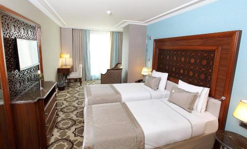 伊斯坦布尔大杜尔马兹酒店 的酒店客房配有两张床和一张书桌