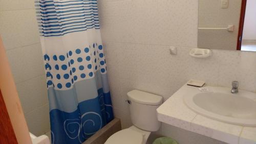 曼克拉Casamar的浴室配有水槽、卫生间和浴帘