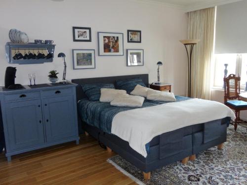 法尔肯堡Gastsuite in Valkenburg aan de Geul的一间卧室配有蓝色的床和枕头