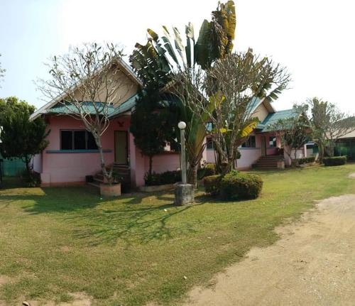 Ban Huai SalokWangtong Resort 2的院子里有树木的粉红色房子