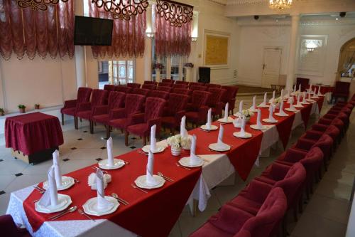 奇姆肯特萨帕尔标准酒店的一间会议室,配有红色的桌子和红色的椅子