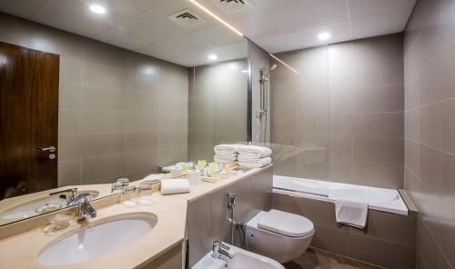迪拜Dusit Princess Residences Dubai Marina的一间带水槽、卫生间和镜子的浴室