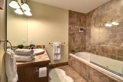 LabelleChic Familiale, Relaxant avec spa en montagnes的带浴缸和盥洗盆的浴室