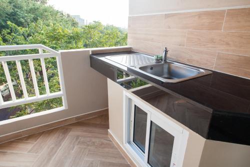 芭堤雅市中心Diana Garden Resort - SHA Extra Plus的窗户旁带水槽的厨房