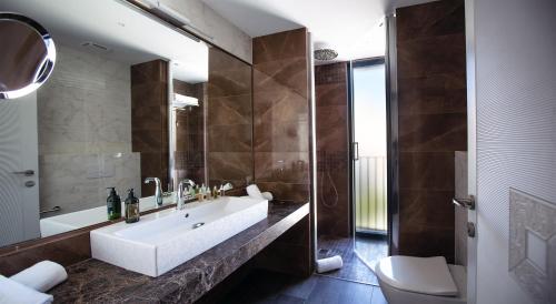 桑特费柳德吉克索尔斯Elke Spa Hotel Superior的带浴缸、盥洗盆和卫生间的浴室