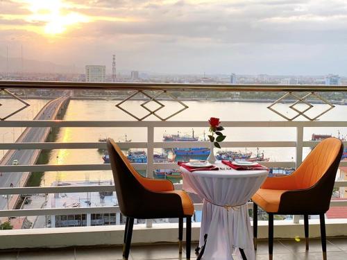 洞海阿曼达酒店的阳台享有海港景致,配有桌椅。