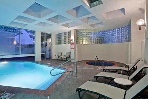 莱克奥斯韦戈波特兰奥斯威戈湖皇冠假日酒店的游泳池位于酒店带桌椅的客房内