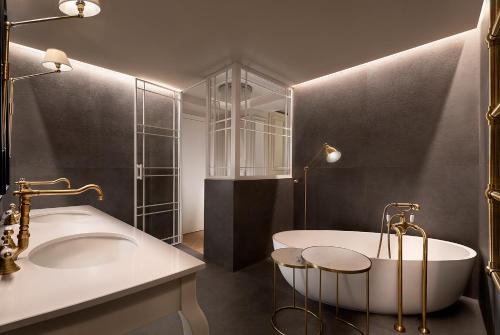 米兰Matilde Boutique Hotel的带浴缸和盥洗盆的浴室