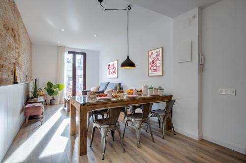 巴塞罗那LucasLand Apartments Barcelona的厨房以及带木桌和椅子的用餐室。