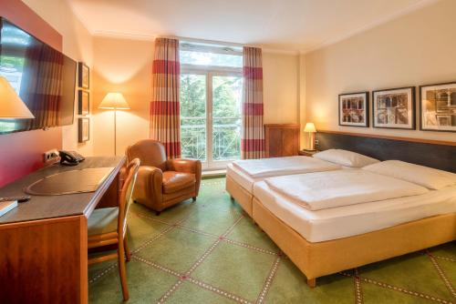 盖尔森基兴布尔莱尔霍夫酒店的配有一张床和一张书桌的酒店客房