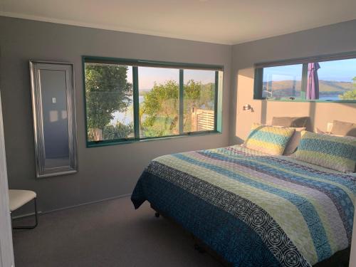 旺阿雷Beach Lane Apartment的一间卧室设有一张床和两个窗户。