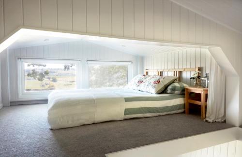 拉伊Extraordinary Huts Ltd的一间卧室设有一张大床和一个窗户。