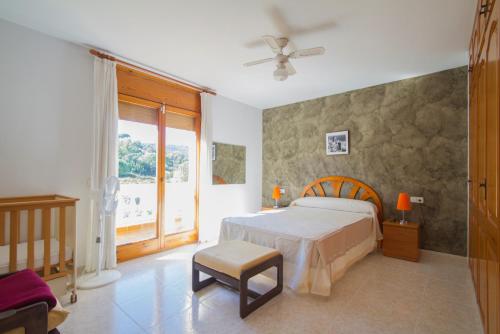 卡隆赫Club Villamar - Ruizman的卧室配有床、椅子和窗户。
