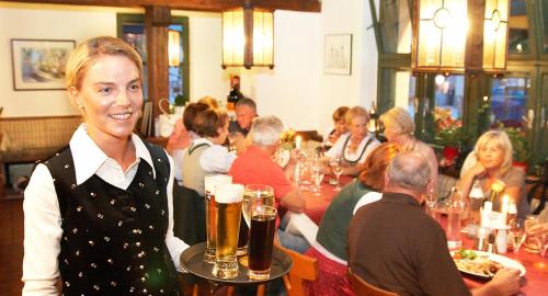 比绍夫斯霍芬格斯特霍夫蒂洛尔维特酒店的餐馆里拿着啤酒盘的女人