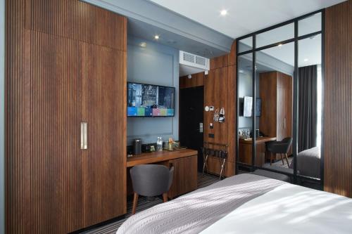 顿河畔罗斯托夫ARKA Hotel by Ginza Project的一间卧室配有一张床、一张桌子和一把椅子