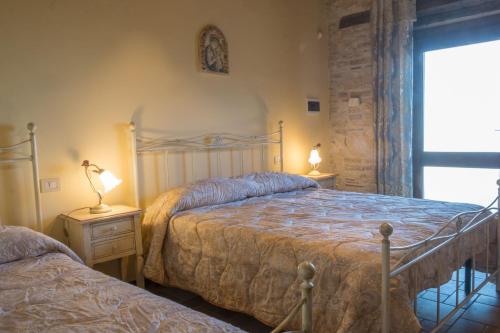 阿斯科利皮切诺Cubanito Bailon的一间卧室设有两张床和两张台灯。