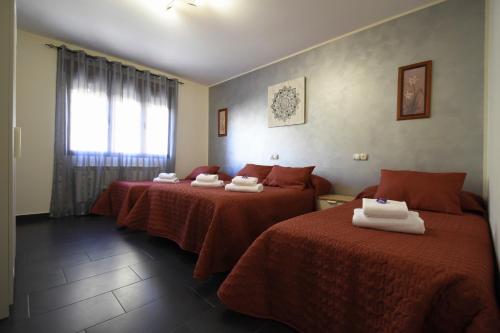 科卡LOS ALISOS的酒店客房,配有两张带红色床单的床