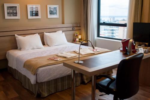 马瑙斯马瑙斯城际酒店的酒店客房配有一张床和一张带电脑的书桌