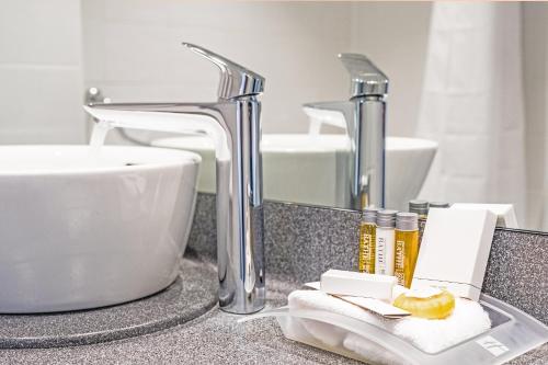 法恩伯勒假日法恩堡酒店的浴室台面上设有水槽和水槽