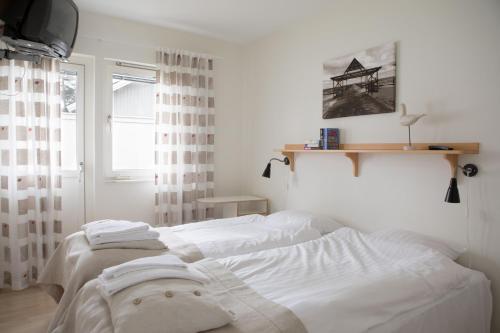 奥胡斯Åhus Resort的一间卧室设有两张白色的床和窗户
