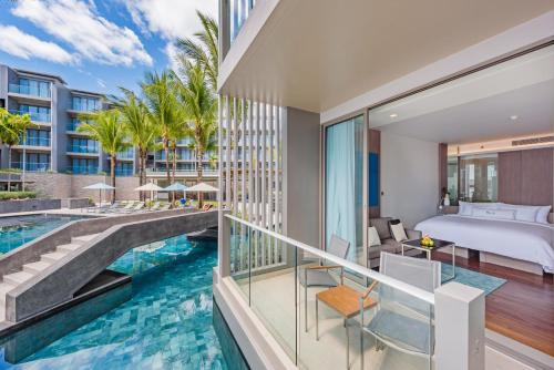 芭东海滩Oceanfront Beach Resort - SHA Extra Plus的享有酒店客房的景色,设有游泳池和一张床