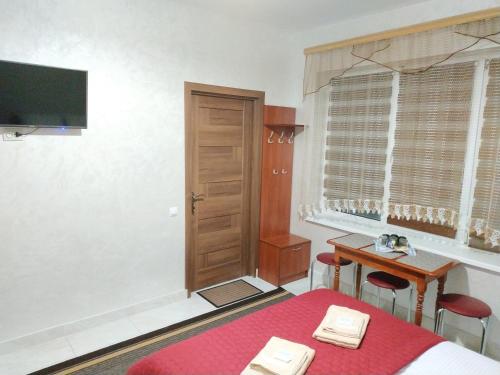 YavorivМотель "КАЛИНА"的客房设有床、书桌和电视。