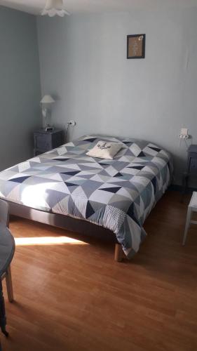 圣马塞尔Gîte de la Bigaillonne的一间卧室配有一张带蓝色和白色棉被的床