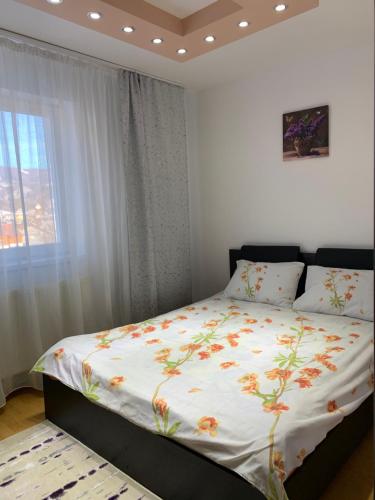 卡夫尼克19 RESIDENCE apartment的一间卧室配有一张带花卉棉被的大床